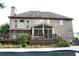 Backyard view featuring a pristine pool, a well-maintained deck, and a brick house exterior at 4663 Mossey Dr, Lithonia, GA 30038