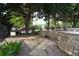 Serene backyard featuring stone walls, lush greenery, and a tranquil ambiance for outdoor relaxation at 4663 Mossey Dr, Lithonia, GA 30038