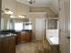 Bathroom featuring tile floors, granite countertops, a soaking tub, and a glass-enclosed shower at 4663 Mossey Dr, Lithonia, GA 30038