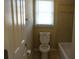Neutral bathroom featuring a toilet, a bathtub, and a window at 4663 Mossey Dr, Lithonia, GA 30038