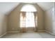 Bright bedroom with vaulted ceilings, large arched window, and neutral decor for a calming atmosphere at 4663 Mossey Dr, Lithonia, GA 30038