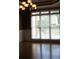 Bright dining room featuring hardwood floors, wainscoting, and a large window overlooking the front yard at 4663 Mossey Dr, Lithonia, GA 30038