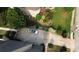 Aerial view of a concrete driveway with a white car parked, surrounded by manicured lawns and landscaping at 4663 Mossey Dr, Lithonia, GA 30038