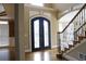 Elegant foyer with hardwood floors, a staircase, and a decorative front door at 4663 Mossey Dr, Lithonia, GA 30038