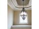 Hallway featuring a decorative chandelier, trim, and decorative window at 4663 Mossey Dr, Lithonia, GA 30038