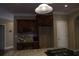 Kitchen area features dark wood cabinets, granite countertops, and a tile backsplash at 4663 Mossey Dr, Lithonia, GA 30038
