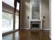 Bright living room featuring hardwood floors, a fireplace with mirror, and large windows at 4663 Mossey Dr, Lithonia, GA 30038