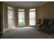 Cozy living room featuring 3 windows, carpet, and 2 chairs at 4663 Mossey Dr, Lithonia, GA 30038