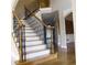 Elegant staircase with decorative iron railings and hardwood steps leading to the upper level at 4663 Mossey Dr, Lithonia, GA 30038