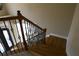 Hardwood staircase with iron balusters leads to the main floor and front door at 4663 Mossey Dr, Lithonia, GA 30038