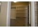 Organized walk-in closet with built-in shelving and ample storage space for clothes and accessories at 4663 Mossey Dr, Lithonia, GA 30038