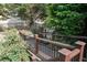 Wooden walkway with railings surrounded by lush greenery and flowers, offering a tranquil outdoor space at 4663 Mossey Dr, Lithonia, GA 30038