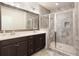 Modern bathroom featuring double vanity, a framed mirror and a glass enclosed shower with tile surround at 318 Lantana Ln, Woodstock, GA 30188