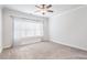 Spacious bedroom featuring neutral walls, carpeted floors, and a large window with sheer curtains at 318 Lantana Ln, Woodstock, GA 30188