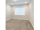 Bright bedroom featuring neutral walls, carpeted floors, and a large window with blinds at 318 Lantana Ln, Woodstock, GA 30188
