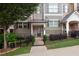 Charming townhome with landscaped front yard, gated entrance, and welcoming facade at 318 Lantana Ln, Woodstock, GA 30188