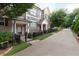 Inviting townhome exterior with well-maintained landscaping, black fence, and walkway at 318 Lantana Ln, Woodstock, GA 30188