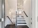 Welcoming foyer with hardwood floors, staircase, and neutral walls, offering a modern and stylish entry at 318 Lantana Ln, Woodstock, GA 30188