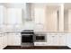 Bright kitchen featuring white cabinets, marble backsplash, and stainless steel appliances at 318 Lantana Ln, Woodstock, GA 30188