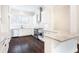 Modern kitchen with stainless steel appliances, white cabinets, granite countertops, and hardwood floors at 318 Lantana Ln, Woodstock, GA 30188