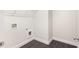 Functional laundry room with tile flooring, white walls, and utility hookups at 318 Lantana Ln, Woodstock, GA 30188