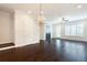 Spacious living room with fireplace, hardwood floors, and elegant lighting, perfect for entertaining at 318 Lantana Ln, Woodstock, GA 30188