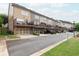 A row of townhomes with garages, decks, and manicured landscaping line a paved street at 318 Lantana Ln, Woodstock, GA 30188