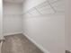 Walk-in closet with wire shelving on a neutral carpet with white trim and walls at 318 Lantana Ln, Woodstock, GA 30188