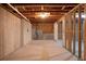 Unfinished basement featuring concrete walls, open ceiling with exposed wood, and rough-in plumbing at 3692 Wartrace Dr, South Fulton, GA 30331