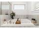 Bright bathroom featuring a large soaking tub with chrome faucet fixtures and neutral tile at 3692 Wartrace Dr, South Fulton, GA 30331