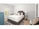 Comfortable bedroom featuring neutral carpet, a window, and a plush bed with stylish decor at 3692 Wartrace Dr, South Fulton, GA 30331