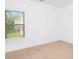 This bedroom has neutral carpet, white walls and a window with a backyard view at 3692 Wartrace Dr, South Fulton, GA 30331