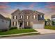 Two-story brick front exterior with covered entrance, well-manicured lawn and sunset at 3692 Wartrace Dr, South Fulton, GA 30331