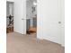 Hallway with neutral carpet, white walls, and white doors provides access to various rooms at 3692 Wartrace Dr, South Fulton, GA 30331