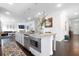Open-concept kitchen and living room features white cabinets, granite countertops, and stainless steel appliances at 3692 Wartrace Dr, South Fulton, GA 30331