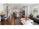 Open-concept living room with a view of the kitchen, featuring stainless steel appliances at 3692 Wartrace Dr, South Fulton, GA 30331
