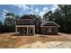 A new two-story brick home with a covered porch and a yard ready for landscaping at 5361 Tuscany Dr, Douglasville, GA 30135