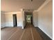 An open hallway features detailed trim work with gray flooring ready to be revealed at 5361 Tuscany Dr, Douglasville, GA 30135