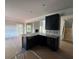 Kitchen featuring dark cabinets, a breakfast bar with a farm sink, and granite countertops at 5361 Tuscany Dr, Douglasville, GA 30135