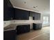 A spacious kitchen featuring stylish, dark cabinetry, granite countertops, and stainless steel hardware at 5361 Tuscany Dr, Douglasville, GA 30135