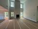 Open-concept living room with fireplace, lots of natural light, and access to the kitchen at 5361 Tuscany Dr, Douglasville, GA 30135