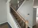 Interior staircase with decorative iron railing leading to the upper level of the home at 5361 Tuscany Dr, Douglasville, GA 30135