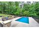 Backyard featuring a swimming pool, lounge chairs, patio and green landscaping at 6095 Fords Nw Rd, Acworth, GA 30101