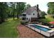 A backyard featuring a pool, landscaped yard, and a well-maintained lawn at 6095 Fords Nw Rd, Acworth, GA 30101