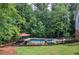 Backyard with an in-ground pool, landscaping, grassy lawn and an umbrella at 6095 Fords Nw Rd, Acworth, GA 30101
