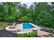 Inviting backyard featuring a pool, lounge chairs, and landscaped area with an umbrella at 6095 Fords Nw Rd, Acworth, GA 30101