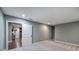 Carpeted basement area leading to living space with hardwood floors, fireplace, and decor at 6095 Fords Nw Rd, Acworth, GA 30101