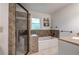 Bathroom featuring a walk-in shower with a glass door, a soaking tub and neutral tile at 6095 Fords Nw Rd, Acworth, GA 30101