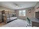 Neutral-toned bedroom features a bunk bed, carpet and a window for ample natural light and a desk at 6095 Fords Nw Rd, Acworth, GA 30101