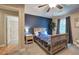 Bedroom featuring a dark blue accent wall, neutral paint, hardwood trim, carpet, and a window at 6095 Fords Nw Rd, Acworth, GA 30101